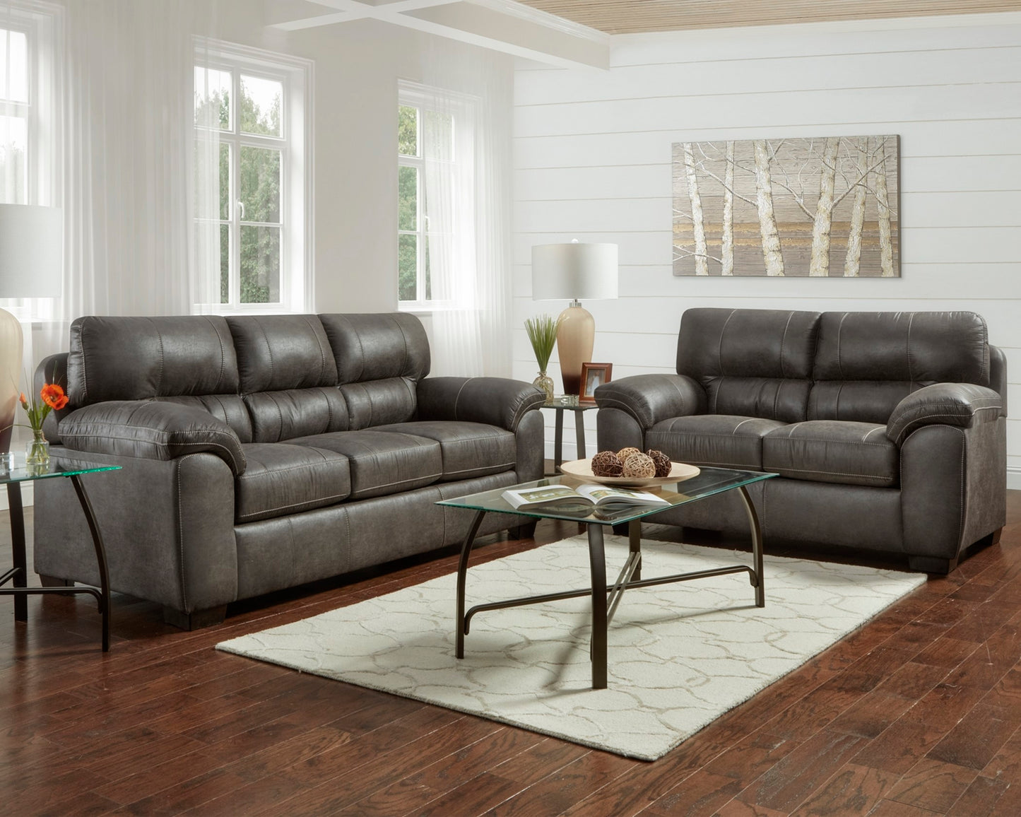 Living room with gray leather sectional sofa and coffee table.