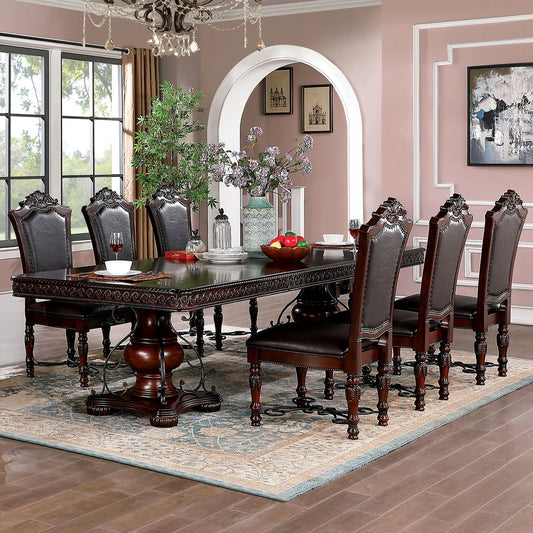 Dining room with a dark wooden table and chairs, decorated with flowers and fruit, in a home setting.