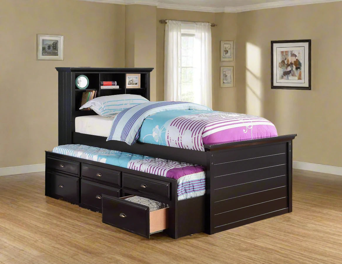 Black wooden bed with storage drawers in a room with blue walls and a window.