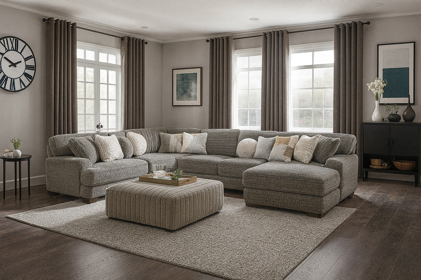 Living room with a gray sectional sofa, ottoman, and decorative items.