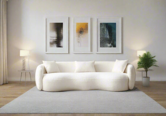 Modern living room with a white sofa, coffee table, and decorative items.