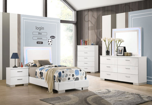 White bedroom furniture set with bed, dresser, and nightstands in a room.