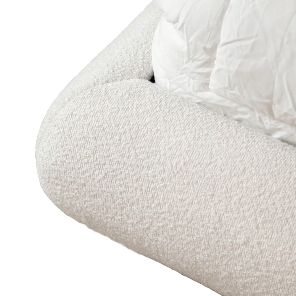 Close-up of a textured white armchair with a white cushion on a white background