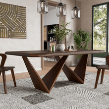 Modern dining room with a wooden table and chairs, featuring a mirror and decorative elements.