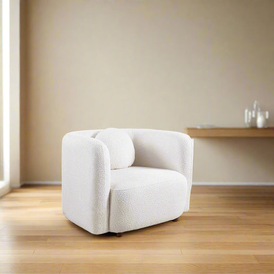 White armchair in a living room with wooden cabinet and window