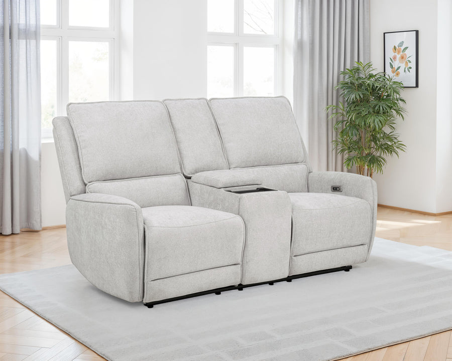 Gray reclining sofa in a living room setting with a plant and window in the background.