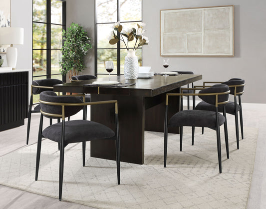 Dining room with a dark wooden table and black chairs in a modern interior setting.