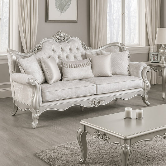 Decorative silver sofa in a stylish living room with a coffee table and framed picture.