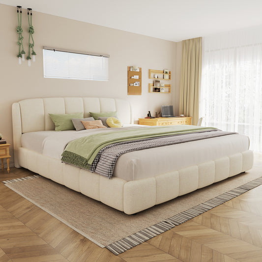 Beige upholstered bed in a modern bedroom with wooden flooring and neutral decor.