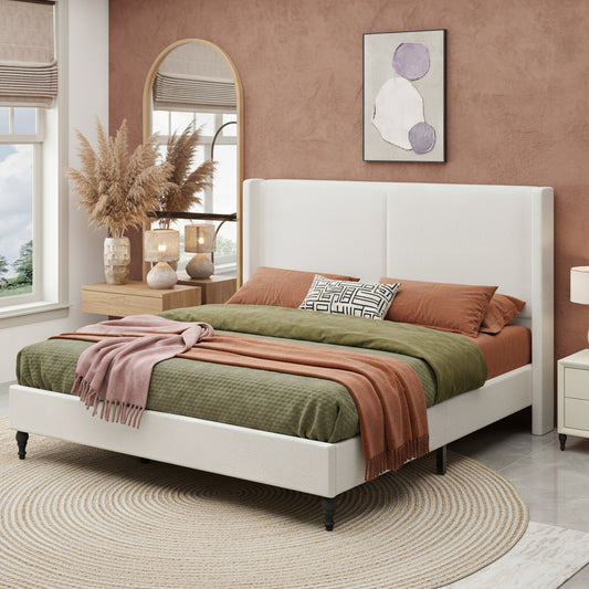 White bed with gray bedding and pink blanket in a bedroom setting.