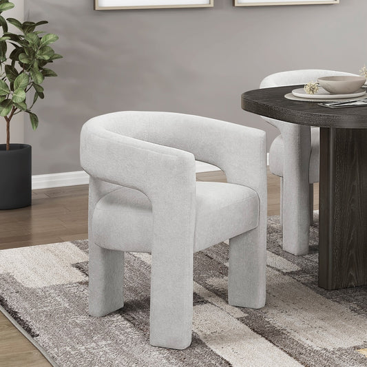 Gray upholstered chairs in a dining room setting with a wooden table and decorative elements.