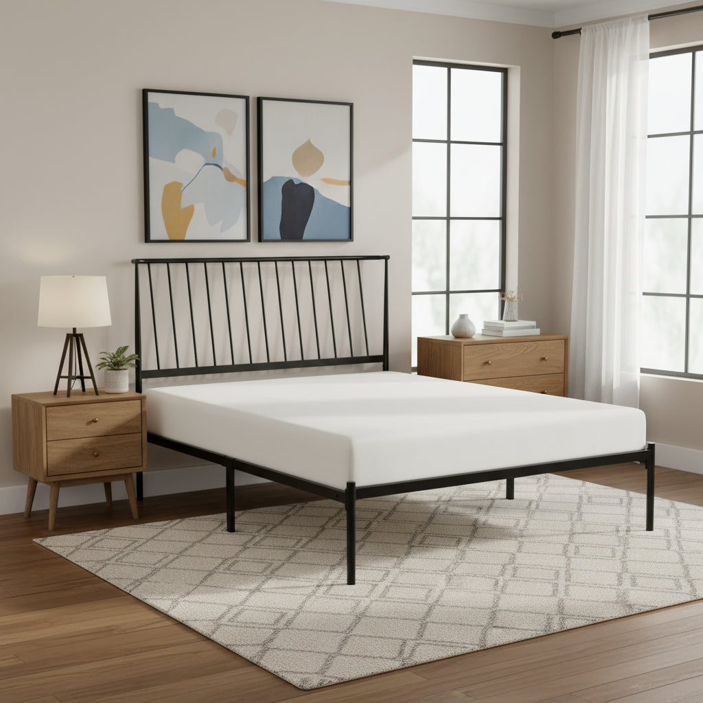 Black metal bed frame with white mattress on a white background