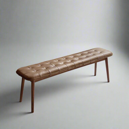 Brown leather bench with wooden legs on a white background