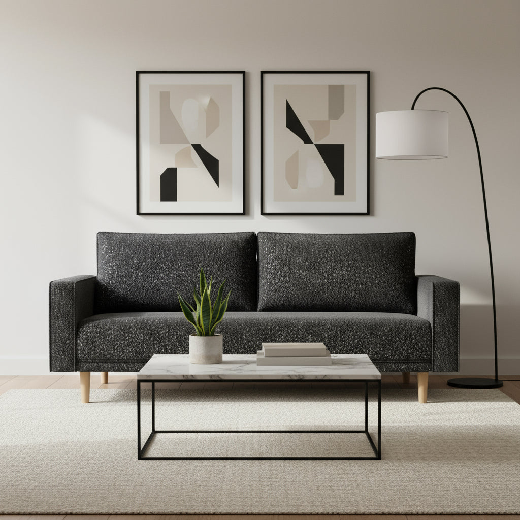 Black sofa with wooden legs on a light gray background