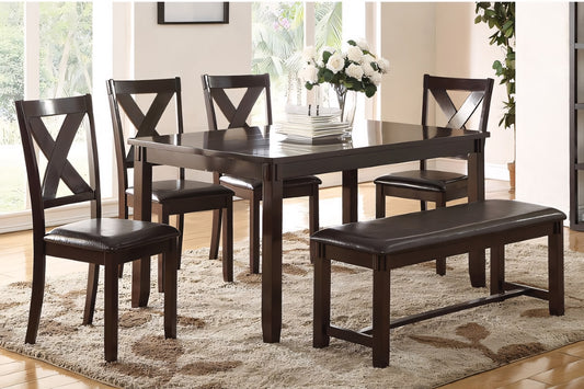 Dining room set with dark wood table and chairs on a patterned rug.