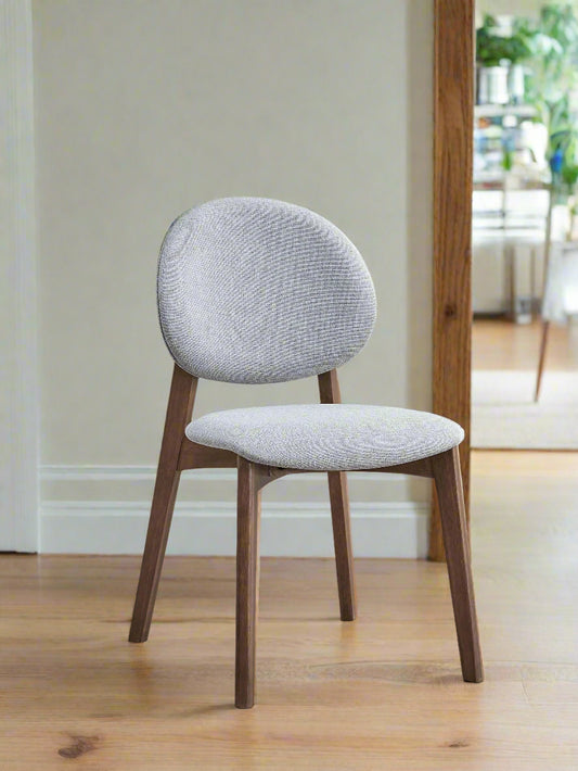 Chair with gray cushioned backrest and seat on a white background