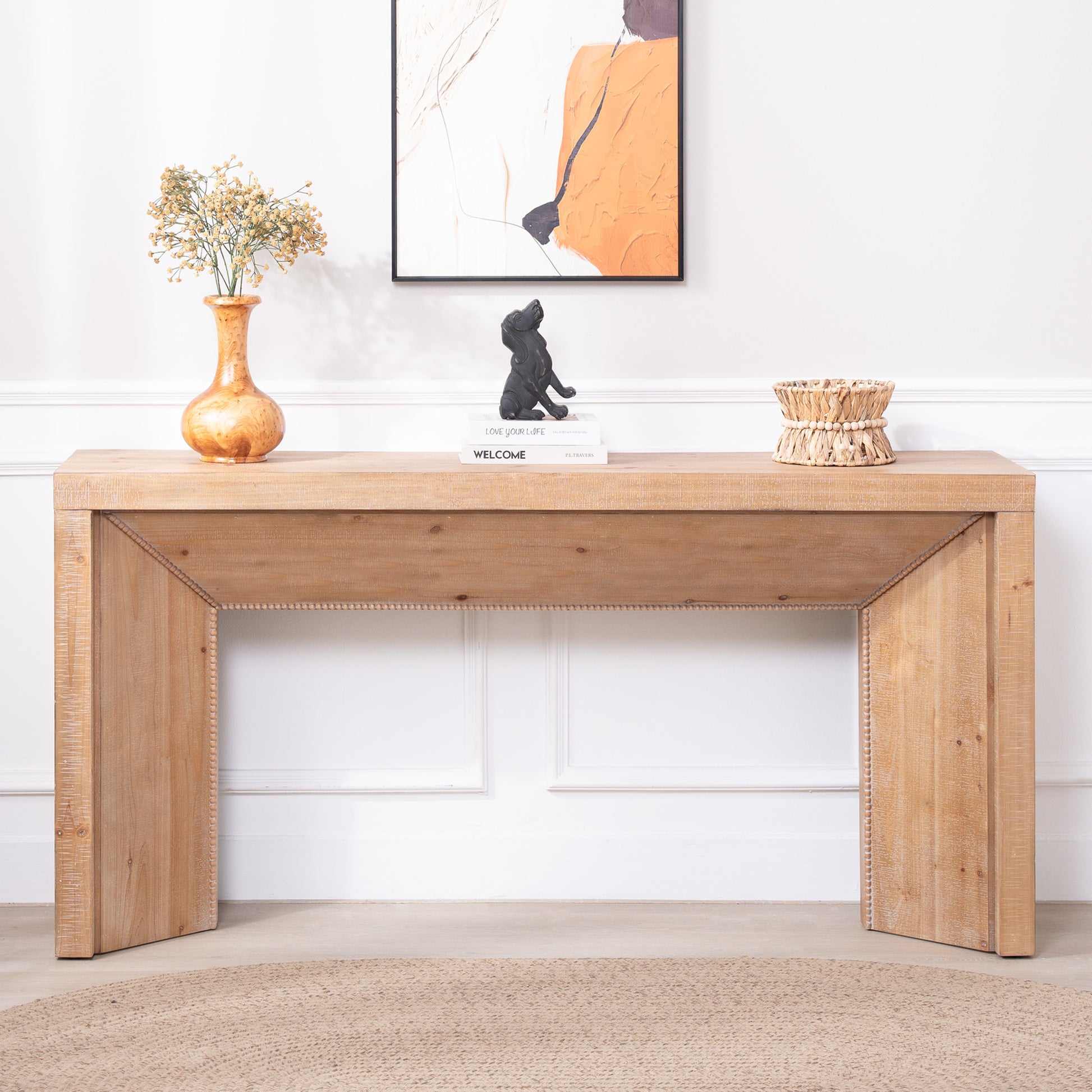 Wooden console table with decorative items against a white wall