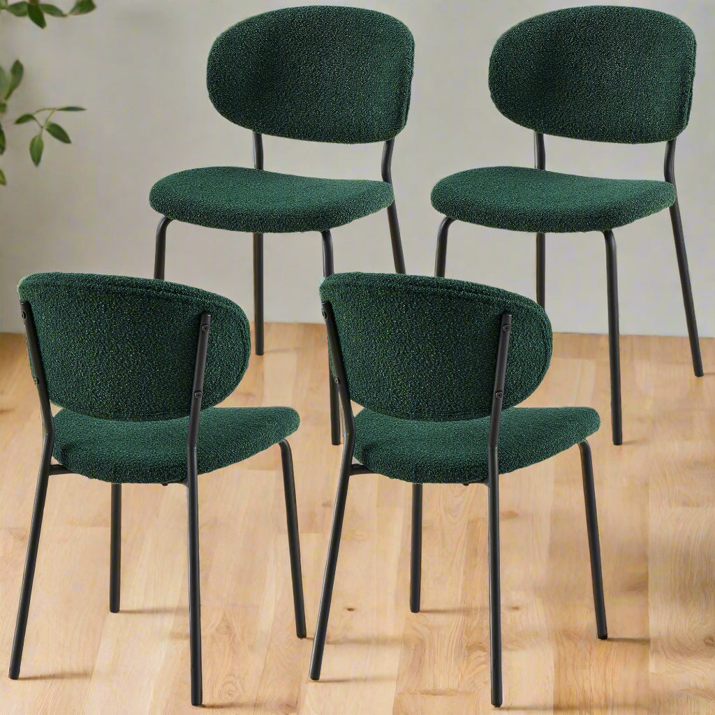 Four green chairs with black frames on a white background