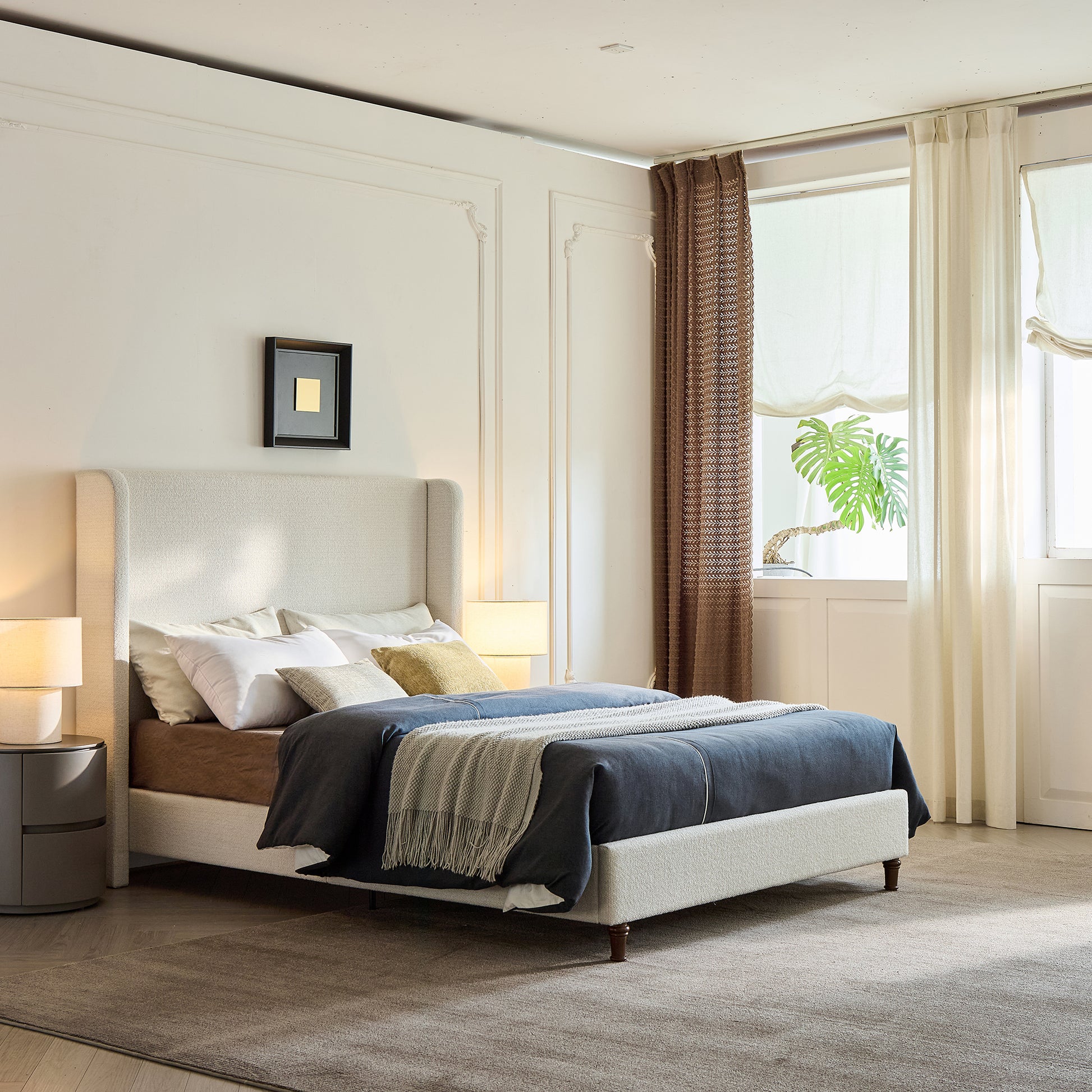 Modern bedroom with a bed, nightstands, and large windows.