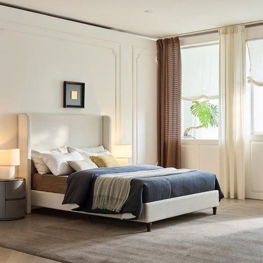 Modern bedroom with a bed, nightstands, and large windows.