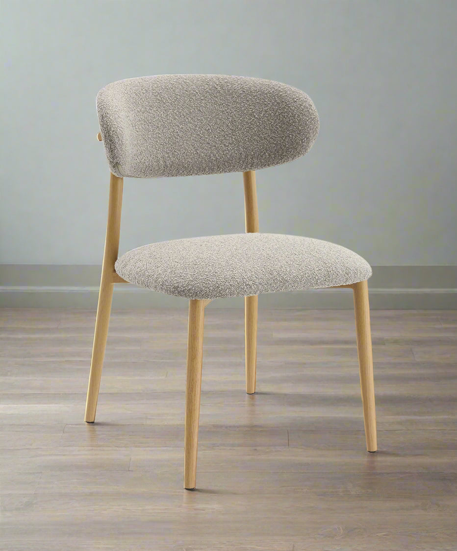 Gray upholstered chair with wooden legs on a white background
