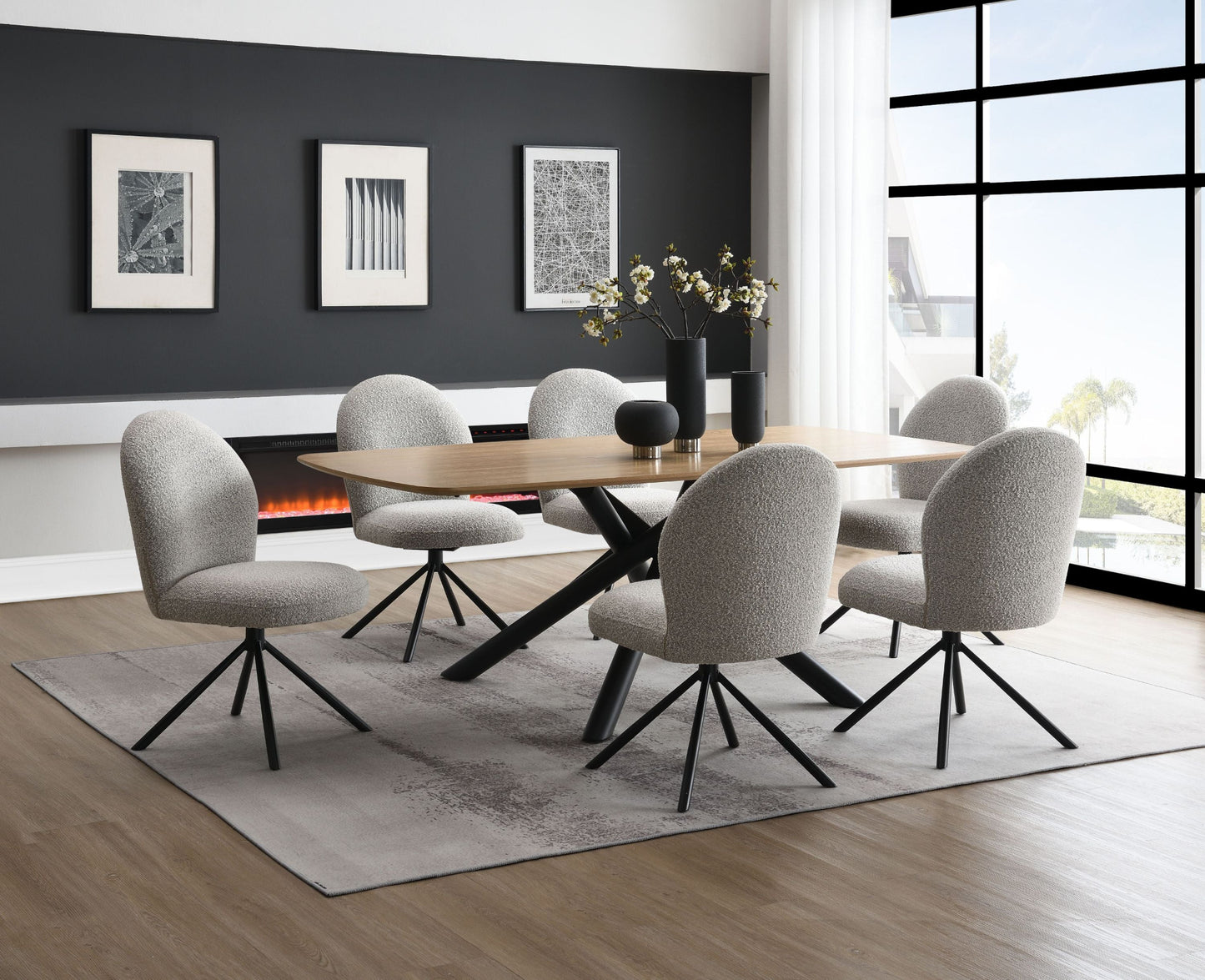Dining room with a round wooden table and six gray chairs in a modern interior setting.
