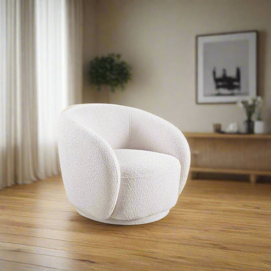 White textured armchair in a bright living room with large windows and decorative elements.