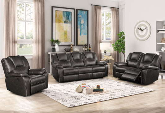 Black leather reclining sofa set in a living room with decor elements.