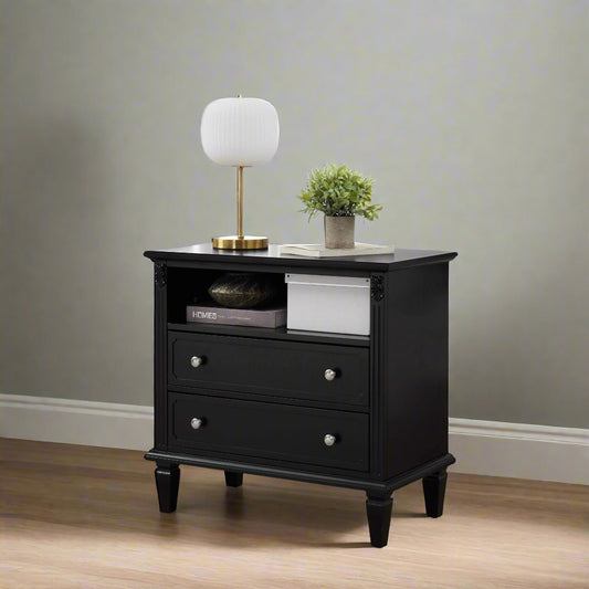 A black 2-drawer farmhouse nightstand with USB ports and a plant on top, placed in a well-lit living room setting.
