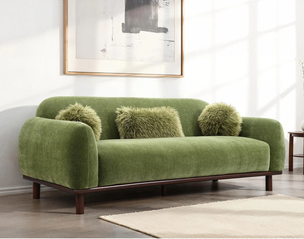 Green sofa with fluffy cushions in a living room setting