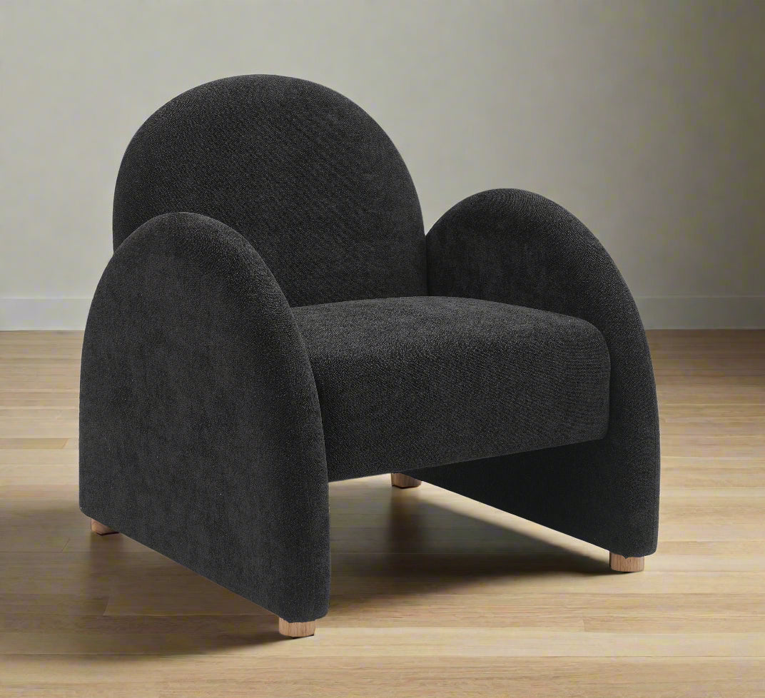 Black armchair with curved design on a white background