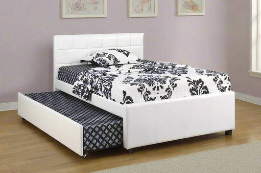 White bed with black and white patterned bedding in a room with a cityscape view.