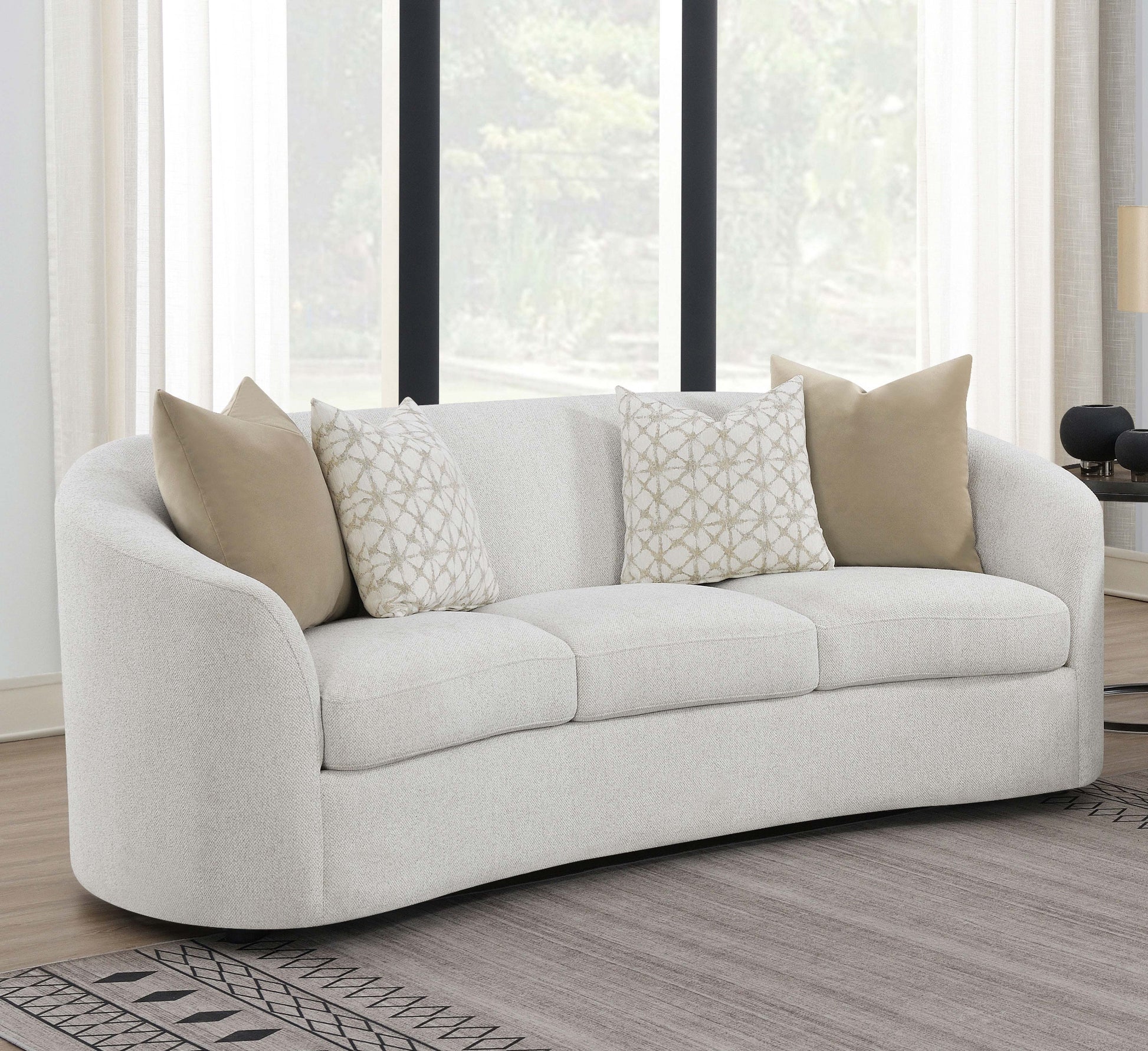 White sofa with patterned cushions in a living room setting