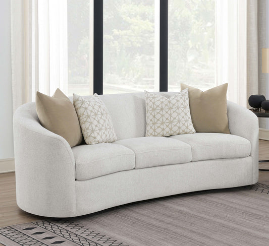 White sofa with patterned cushions in a living room setting