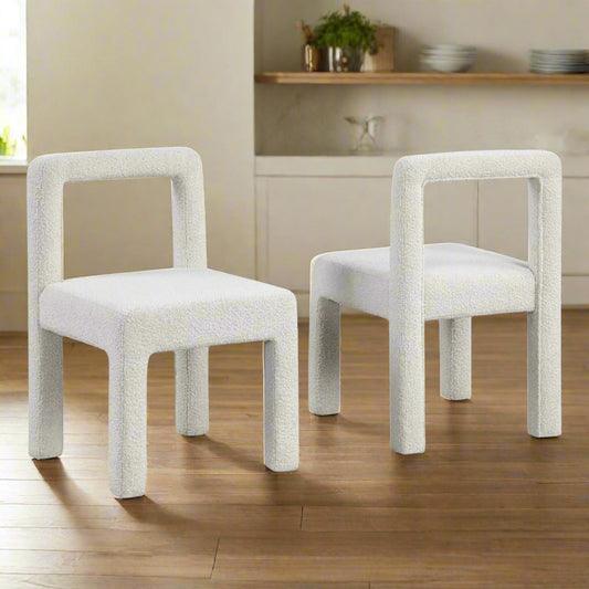 Two white chairs with a textured surface on a white background