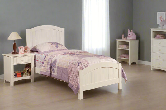 Children's bedroom with white bed, nightstand, and dresser.