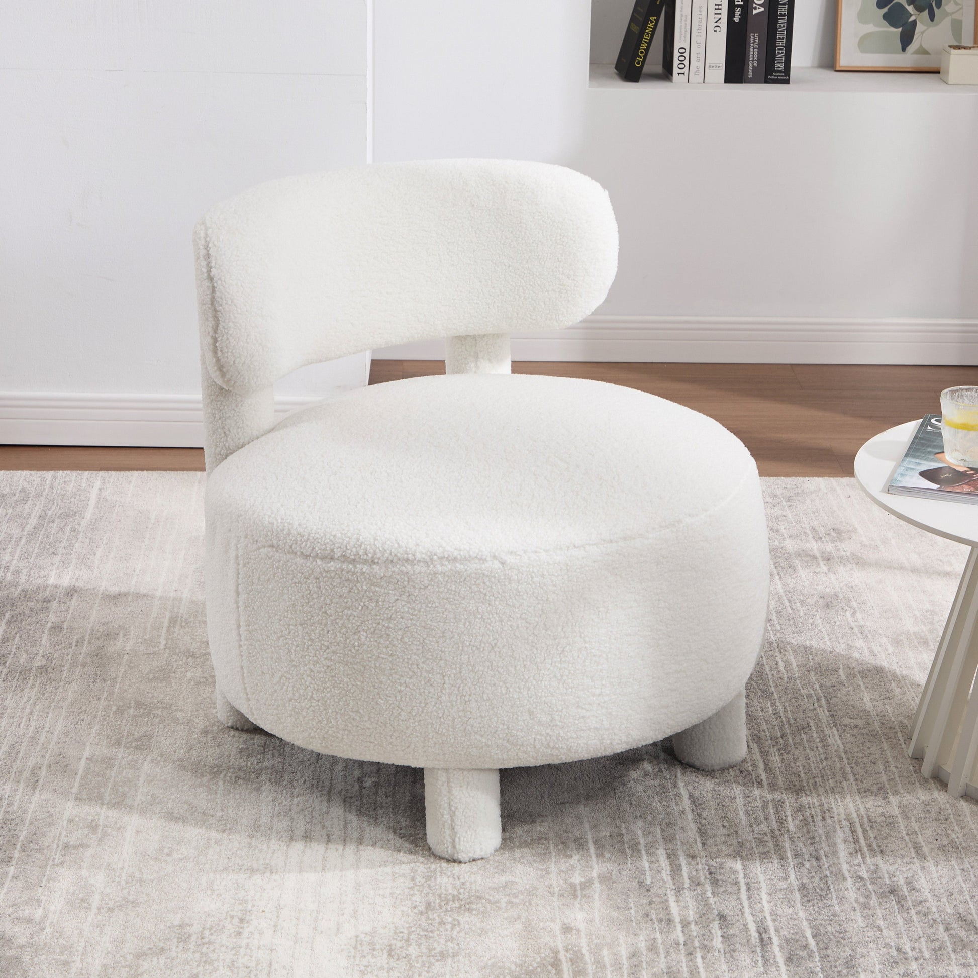 White textured chair in a room with a rug and table