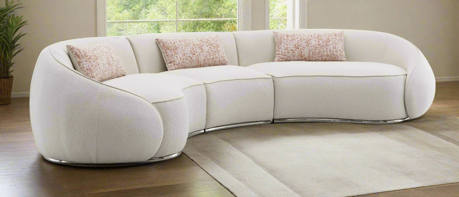 Modern beige sectional sofa with decorative pillows on a white background