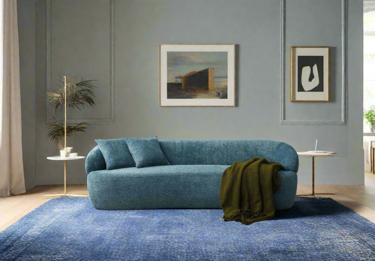 Blue sofa in a modern living room with decor elements.