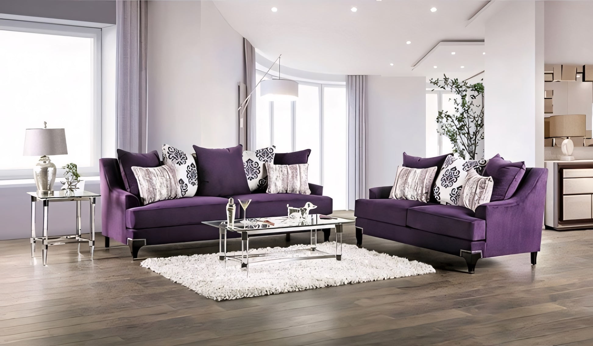 Modern living room with purple sofas and decorative pillows.
