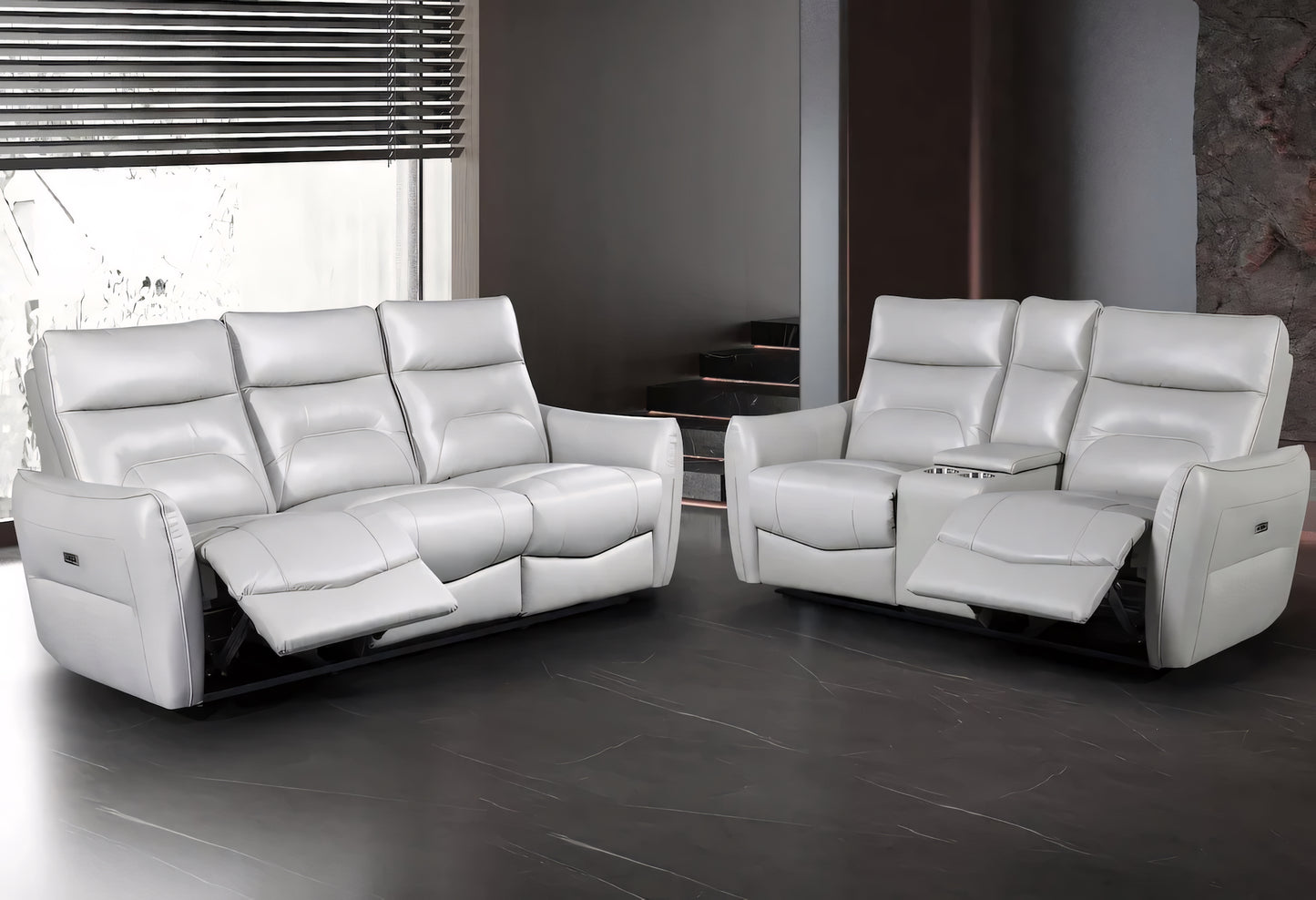 White leather reclining sofa set in a modern room with large windows.