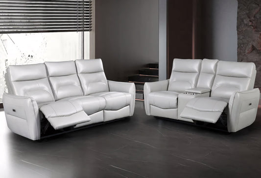 White leather reclining sofa set in a modern room with large windows.