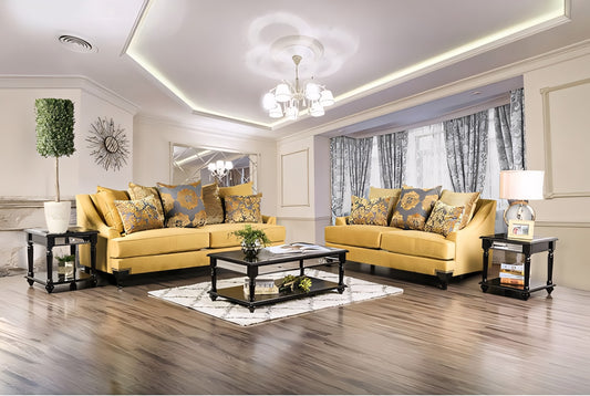 Living room with yellow sofa, decorative pillows, and a coffee table.